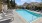 a swimming pool with chairs around it
