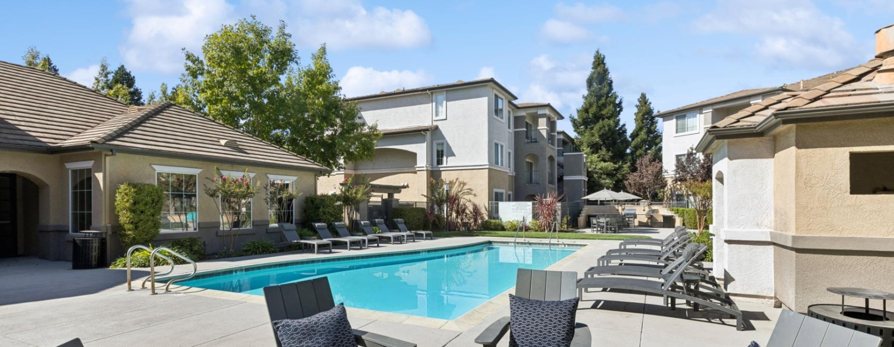 a pool with chairs around it