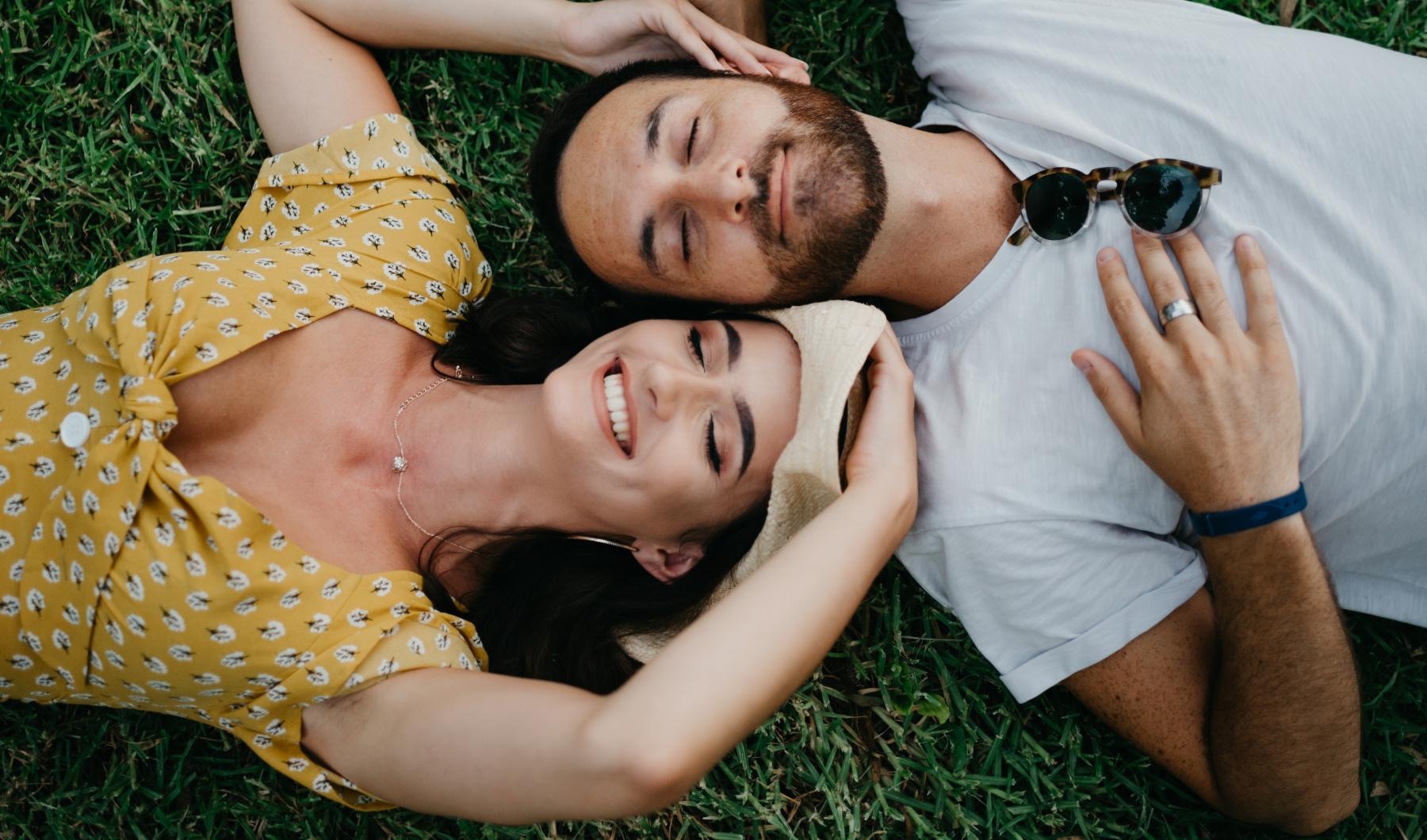 The essence of exceptional living a man and woman lying in the grass