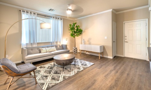 a living room with a sofa and chairs